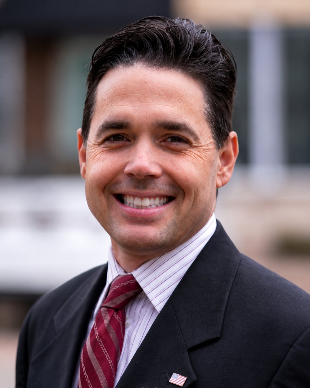 Dr. Paul Chabot, keynote speaker, in a dark suit and red tie
